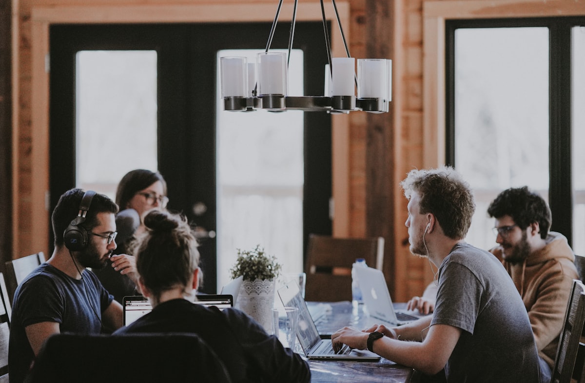 Kleines Team arbeitet am gemeinsamen Tisch
