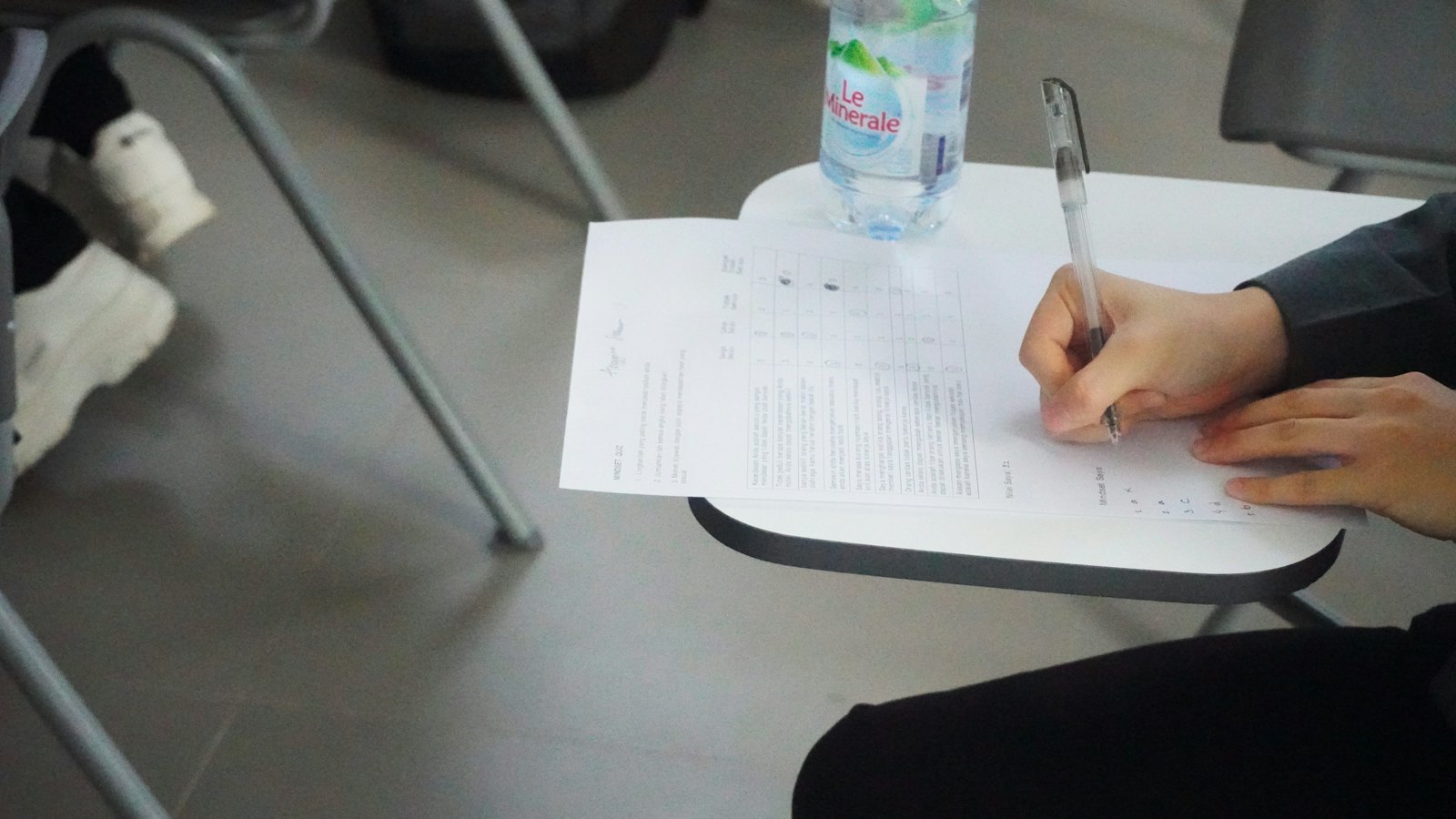 Eine Person füllt einen Test auf Papier aus